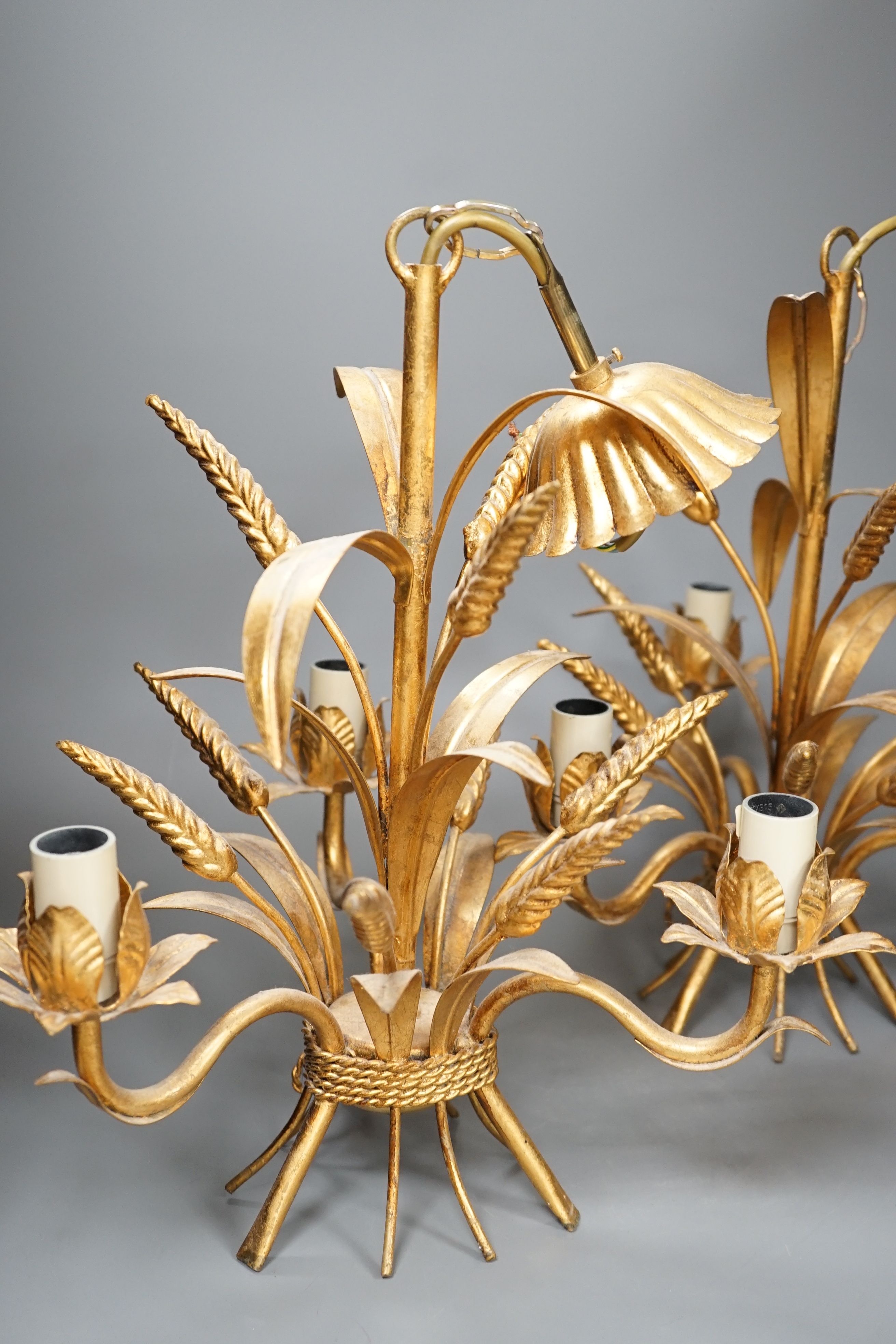 A pair of gilt metal wheat sheaf three light chandeliers